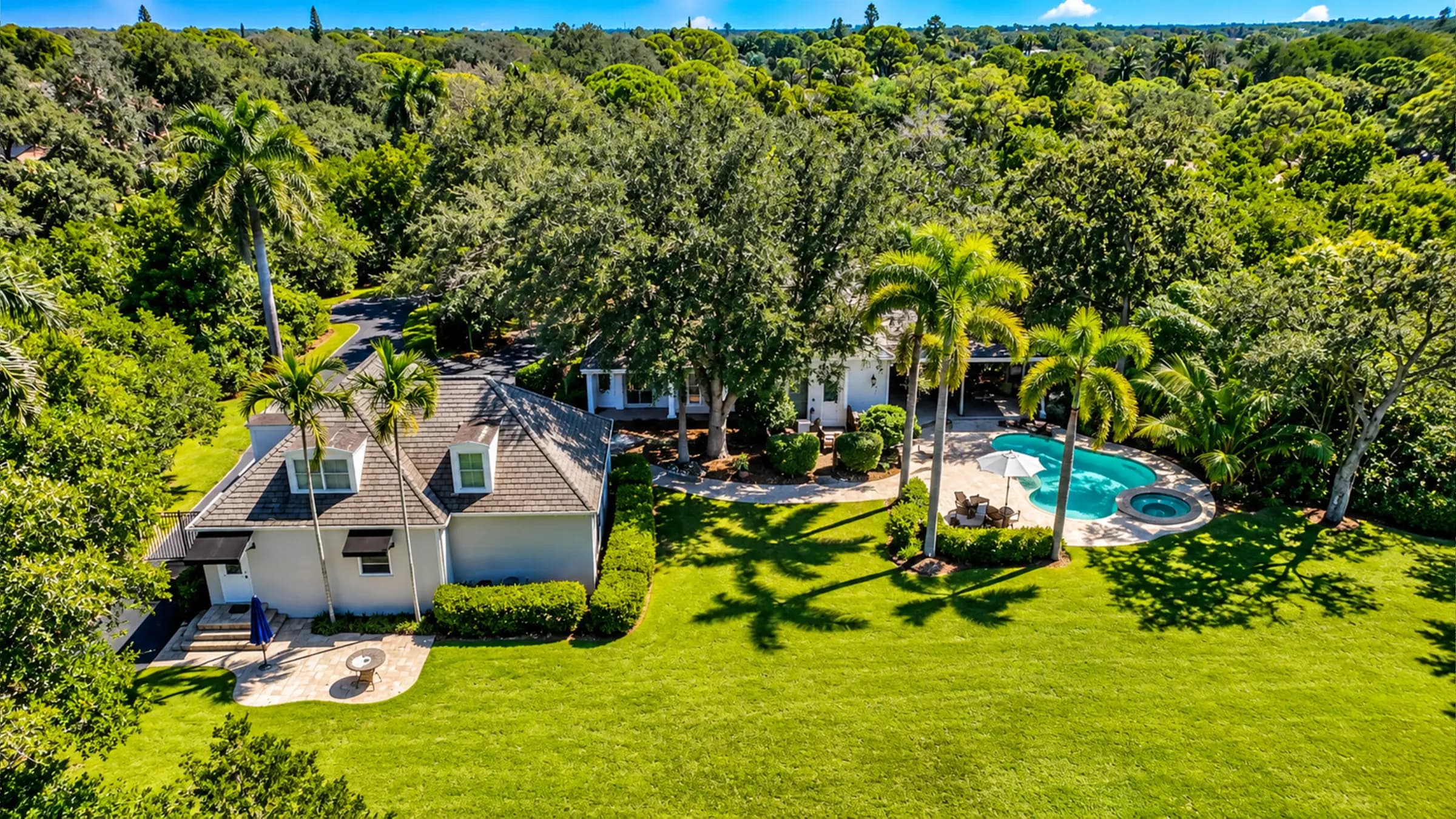 Aerial view of the 216 Cocohatchee residence, pool and lawn above the Cocohatchee River