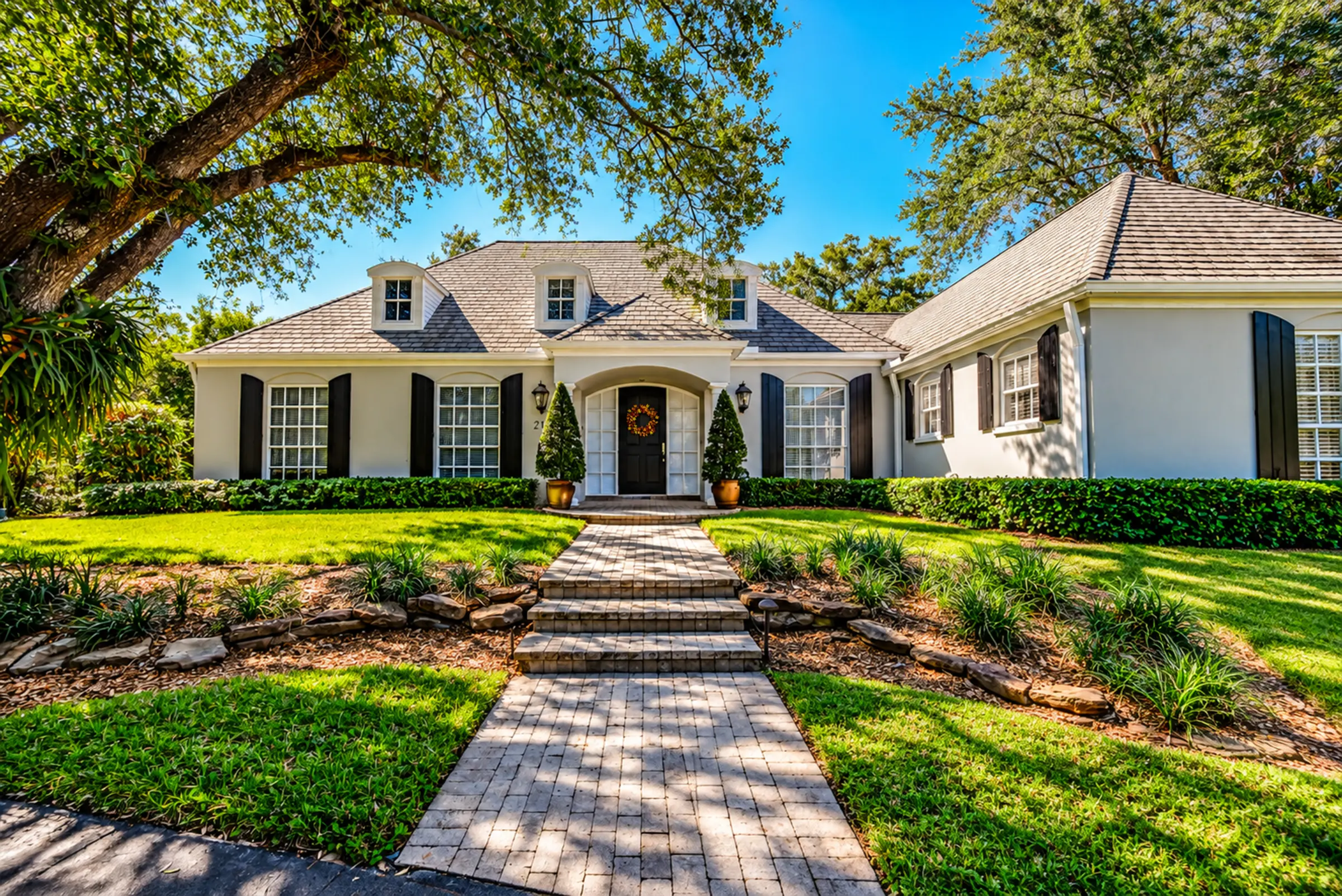 Front of the French-style cottage with its brick walk