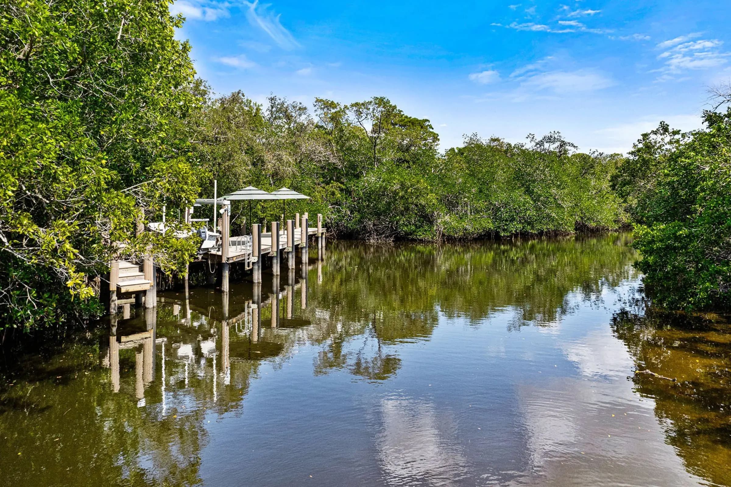 Morning reflections on the Cocohatchee River from the dock